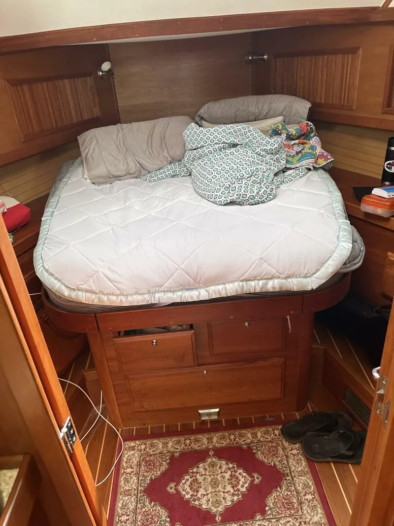 Slide: The Image of Cozy cabin interior of 2003 Sabre 36 Fly Bridge Sedan with bed and wooden furnishings. - 43