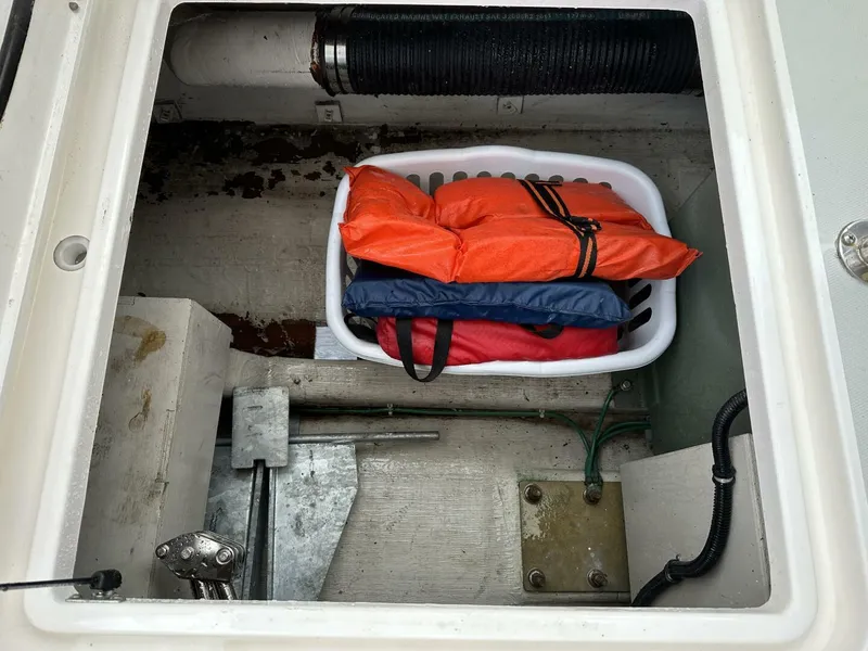Slide: The Image of 2003 Sabre 36 Fly Bridge Sedan storage compartment with life jackets and equipment. - 45