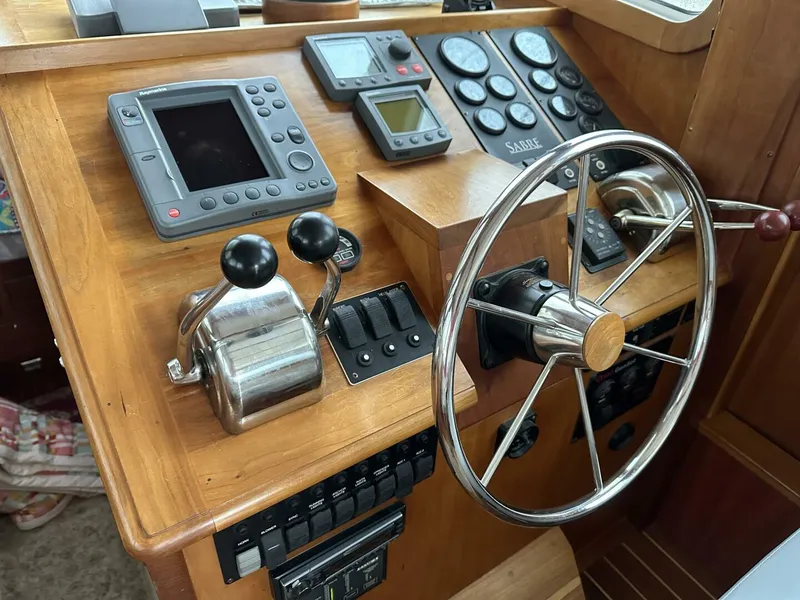 Slide: The Image of Control panel of 2003 Sabre 36 Fly Bridge Sedan with steering wheel and navigation instruments. - 8
