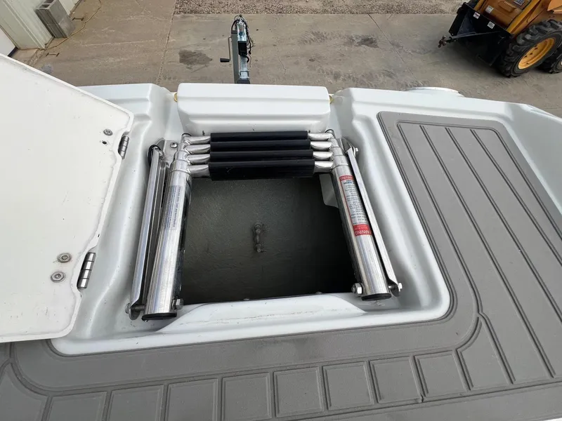 Slide: The Image of 2019 Crownline Eclipse E285 boat ladder compartment, open with hydraulic supports. - 12