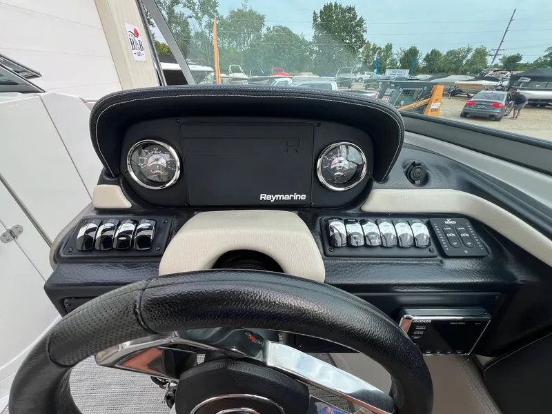 Slide: The Image of 2019 Crownline Eclipse E285 dashboard with Raymarine electronics and control switches. - 18