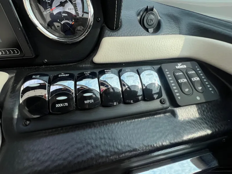 Slide: The Image of Control panel of 2019 Crownline Eclipse E285 boat with switches and gauges. - 19