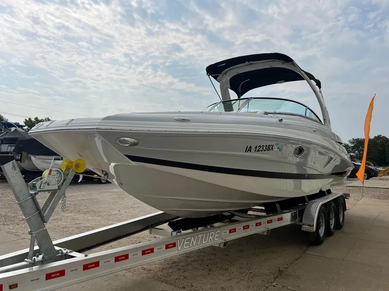 Slide: The Image of 2019 Crownline Eclipse E285 boat on trailer under cloudy sky. - 2