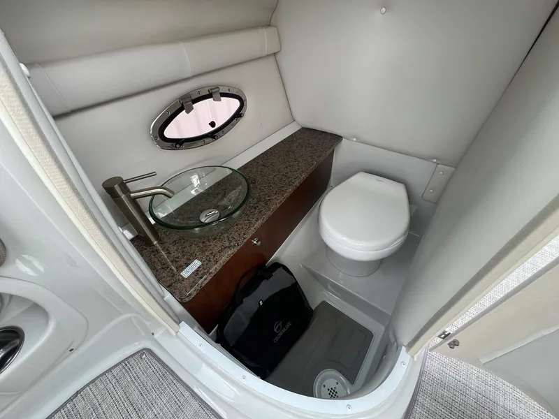 Slide: The Image of 2019 Crownline Eclipse E285 boat bathroom with modern sink and toilet. - 25