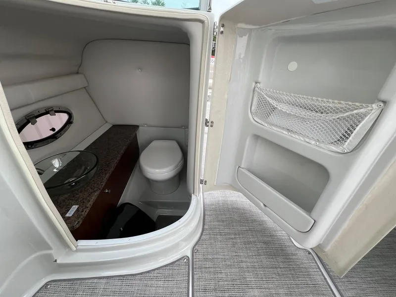 Slide: The Image of 2019 Crownline Eclipse E285 boat interior bathroom with toilet and sink. - 26