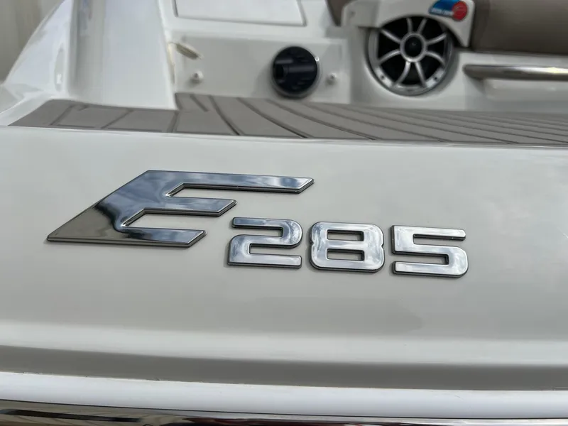 Slide: The Image of 2019 Crownline Eclipse E285 boat emblem on deck, showcasing sleek design. - 3