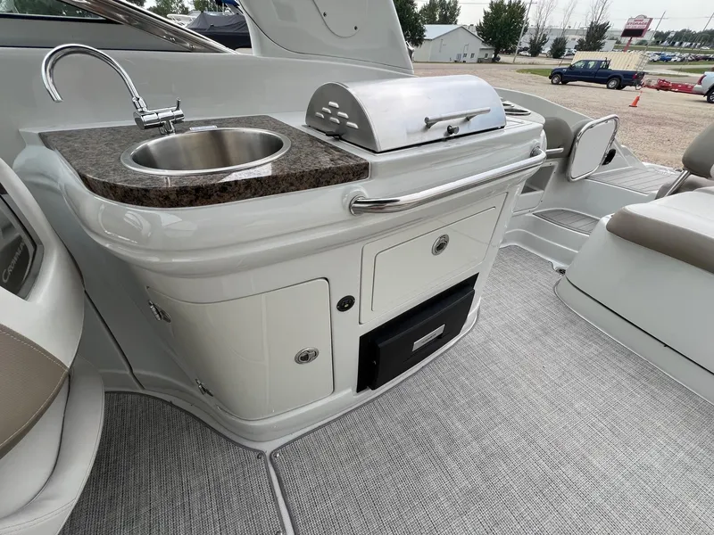 Slide: The Image of 2019 Crownline Eclipse E285 boat interior with sink and grill station. - 32