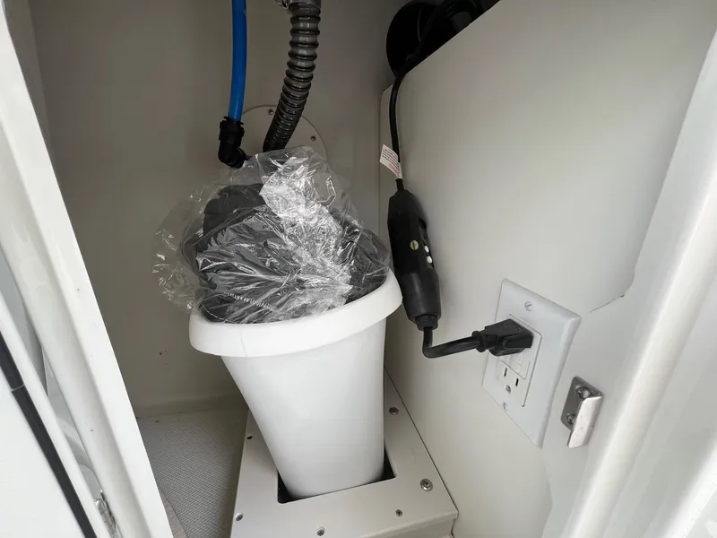 Slide: The Image of 2019 Crownline Eclipse E285 boat interior with electrical outlet and wiring. - 33