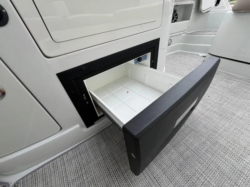 Slide: The Image of 2019 Crownline Eclipse E285 boat interior with open storage compartment. - 34