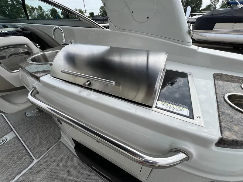 Slide: The Image of 2019 Crownline Eclipse E285 boat interior with Kenyon grill and sink. - 35