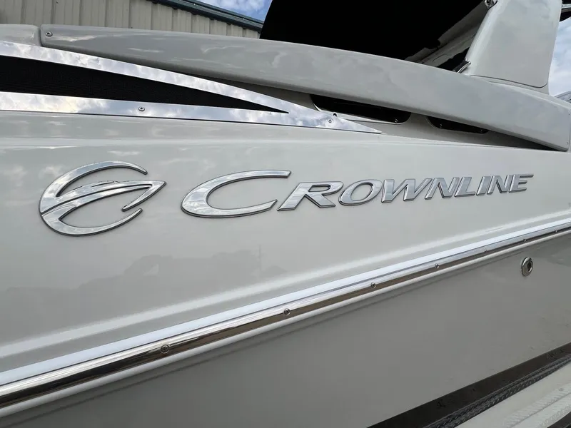 Slide: The Image of 2019 Crownline Eclipse E285 boat logo on sleek white exterior. - 4