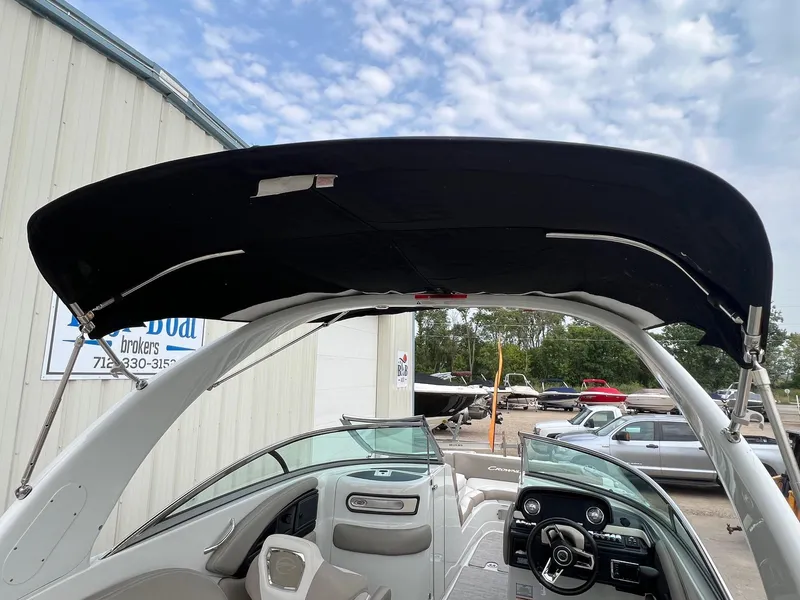 Slide: The Image of 2019 Crownline Eclipse E285 boat interior with canopy, dashboard, and seating. - 42