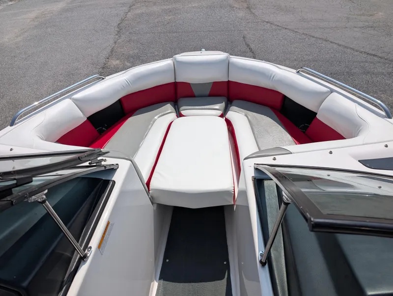 Slide: The Image of 2014 Moomba Mondo boat interior with red and white seating, open bow design. - 15