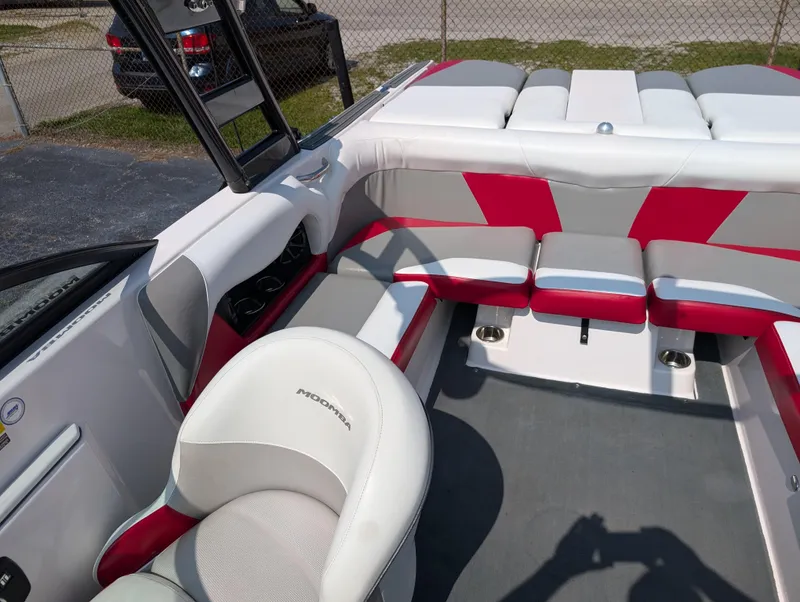 Slide: The Image of 2014 Moomba Mondo boat interior with red and gray seating, showcasing modern design. - 16