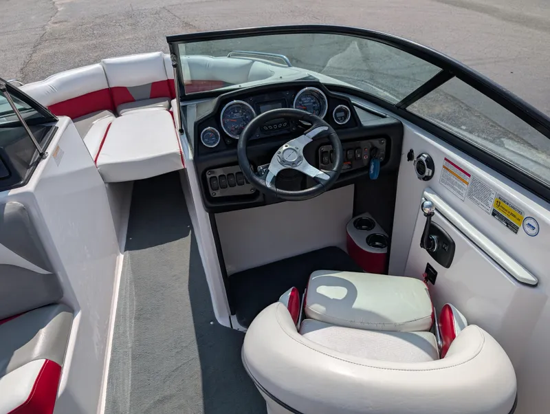 Slide: The Image of 2014 Moomba Mondo boat interior with steering wheel and seating. - 18
