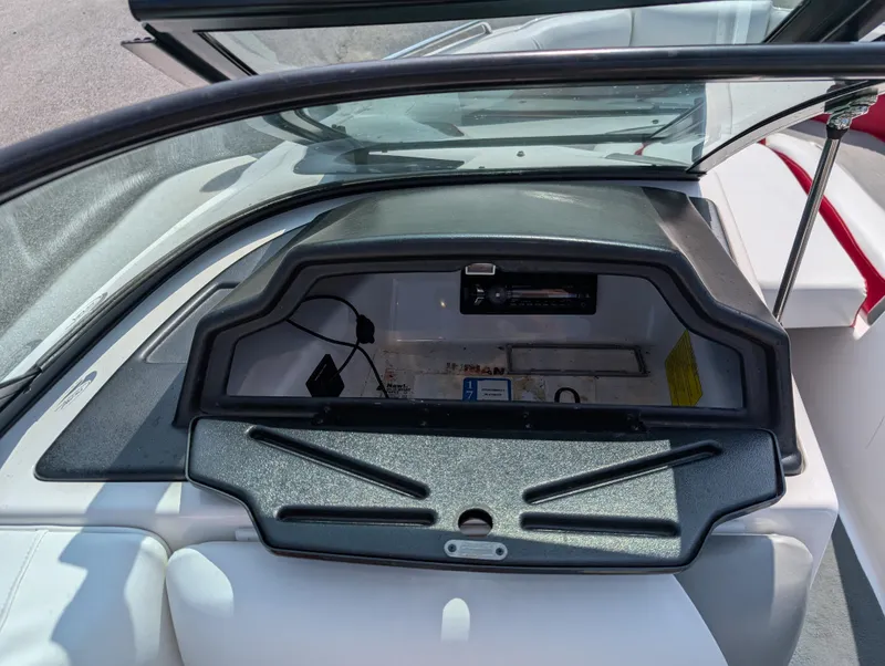 Slide: The Image of 2014 Moomba Mondo boat dashboard with open storage compartment and visible wiring. - 19