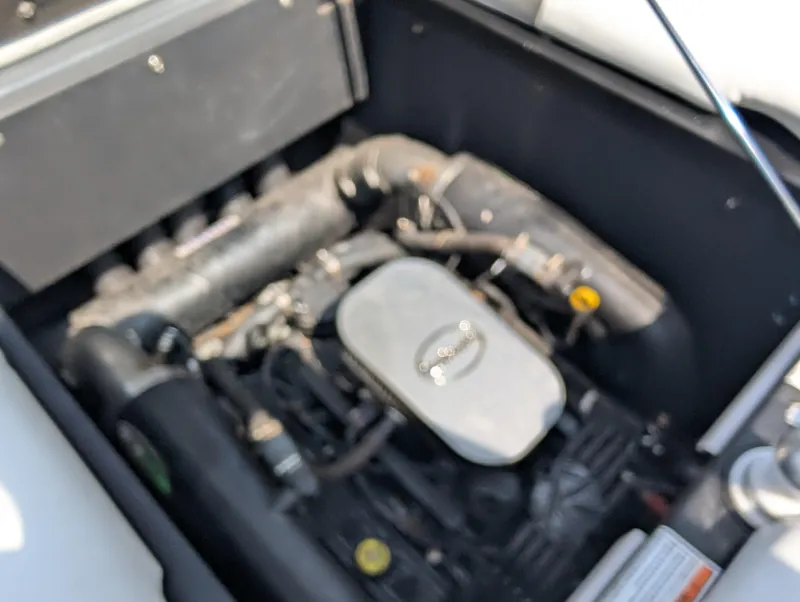 Slide: The Image of Engine compartment of a 2014 Moomba Mondo boat, featuring visible components and wiring. - 20