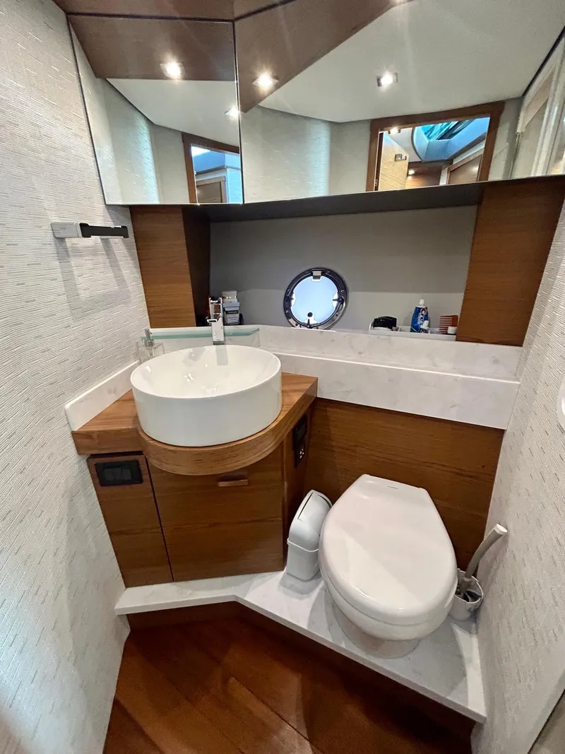 Slide: The Image of 2022 Tiara Yachts C39 Coupe bathroom with modern fixtures and wood accents. - 11
