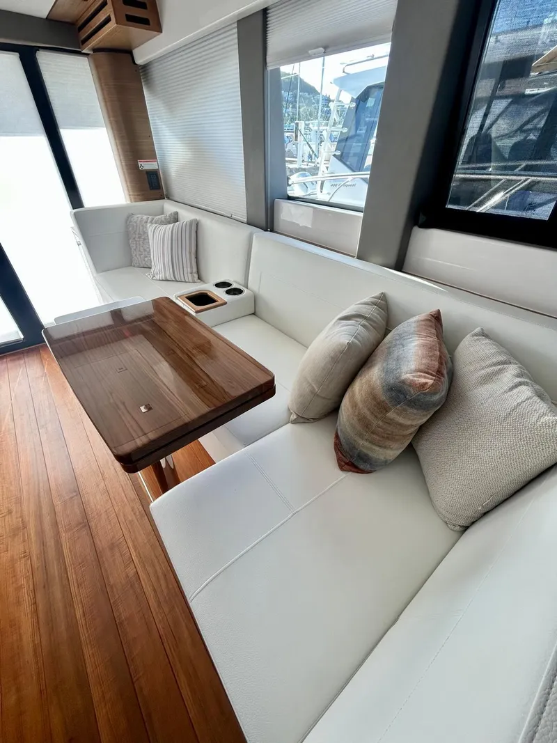 Slide: The Image of Interior of 2022 Tiara Yachts C39 Coupe with elegant seating and wooden table. - 13