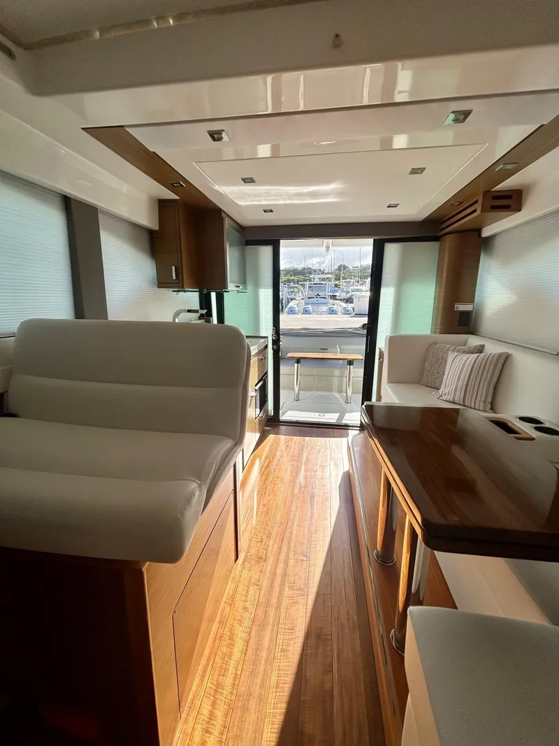 Slide: The Image of Interior of 2022 Tiara Yachts C39 Coupe with modern furnishings and wood flooring. - 4