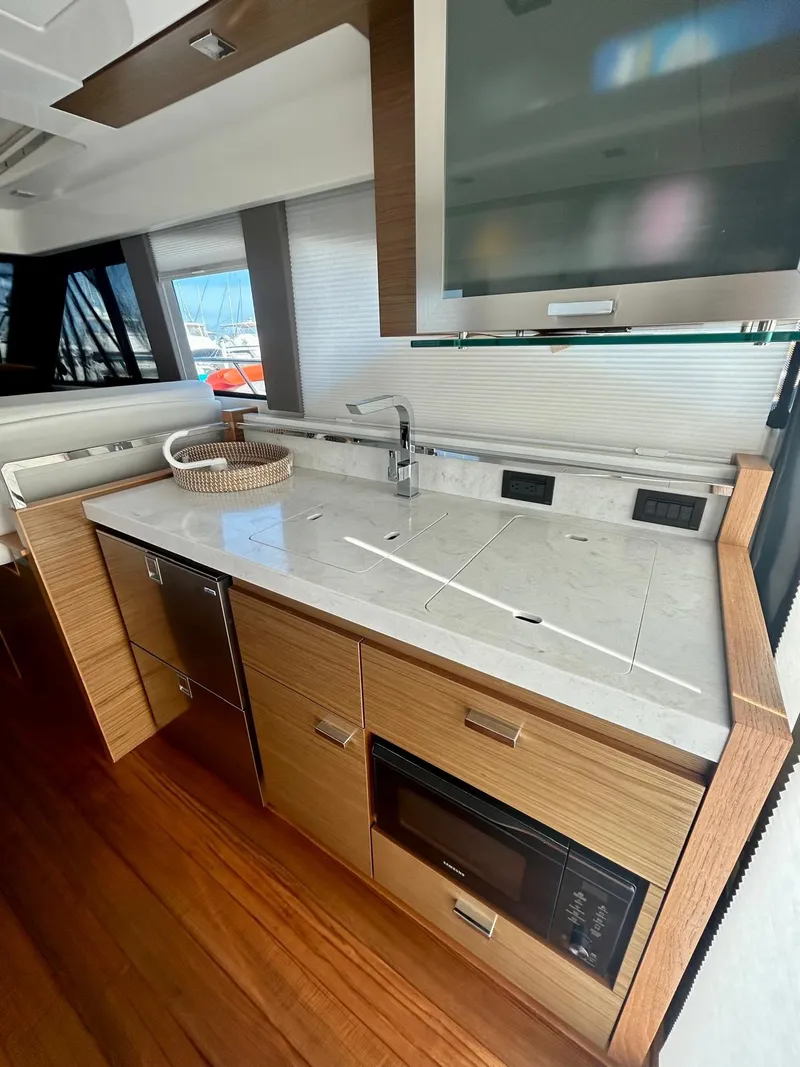 Slide: The Image of 2022 Tiara Yachts C39 Coupe interior kitchen with modern appliances and sleek design. - 5