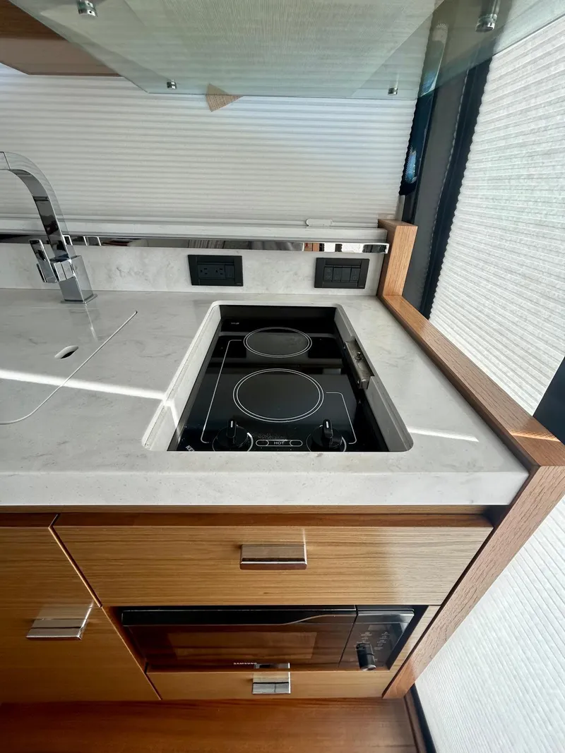 Slide: The Image of Modern kitchen in 2022 Tiara Yachts C39 Coupe with sleek stovetop and sink. - 6