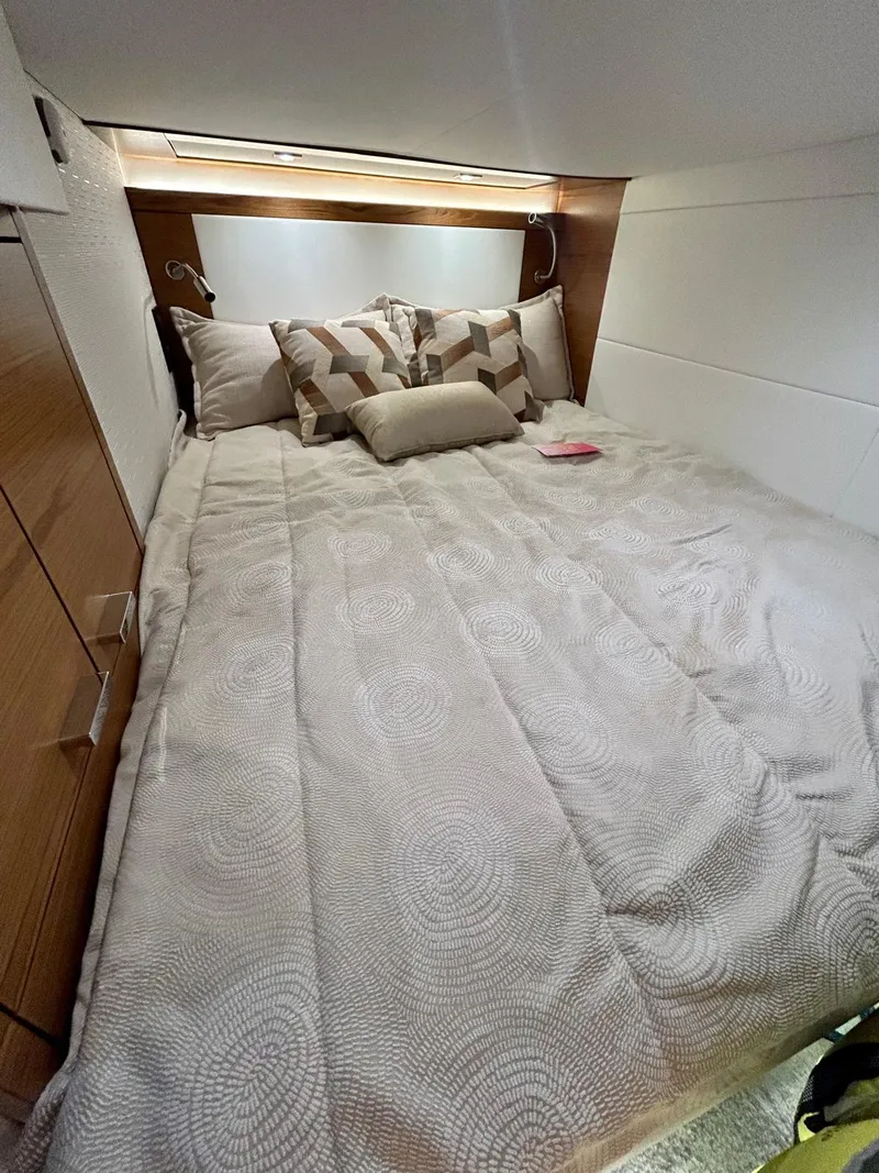 Slide: The Image of 2022 Tiara Yachts C39 Coupe cabin with cozy bed and modern decor. - 9