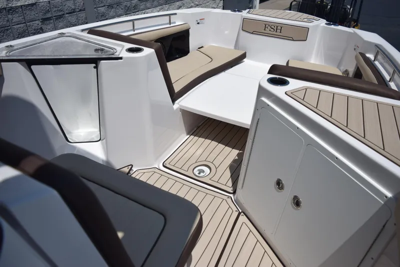 Slide: The Image of 2025 Yamaha Boats 255 FSH Sport E interior with seating and storage compartments. - 11