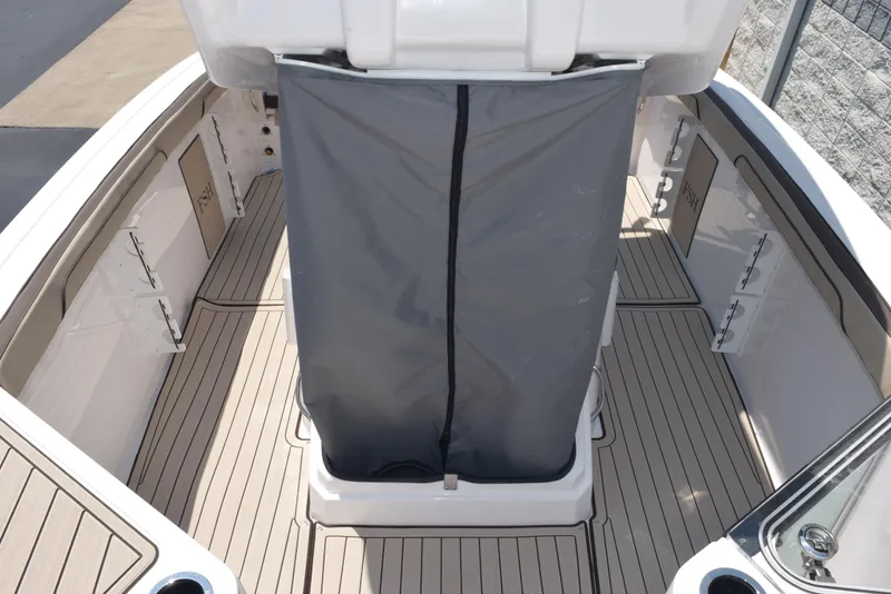 Slide: The Image of 2025 Yamaha Boats 255 FSH Sport E interior with gray cover and sleek deck design. - 17