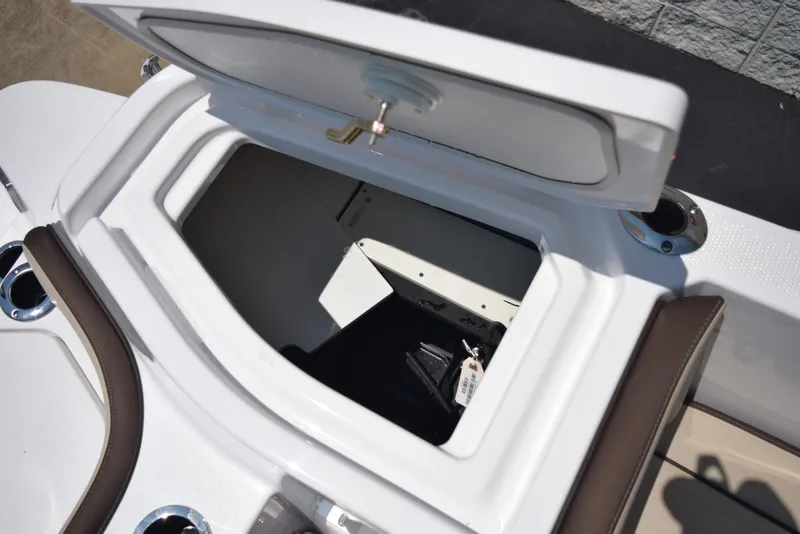 Slide: The Image of 2025 Yamaha Boats 255 FSH Sport E storage compartment with open hatch. - 21