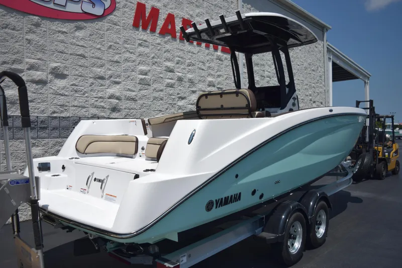 Slide: The Image of 2025 Yamaha Boats 255 FSH Sport E on trailer, displayed outside a marine dealership. - 3