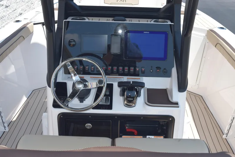 Slide: The Image of 2025 Yamaha Boats 255 FSH Sport E dashboard with steering wheel and electronic controls. - 7