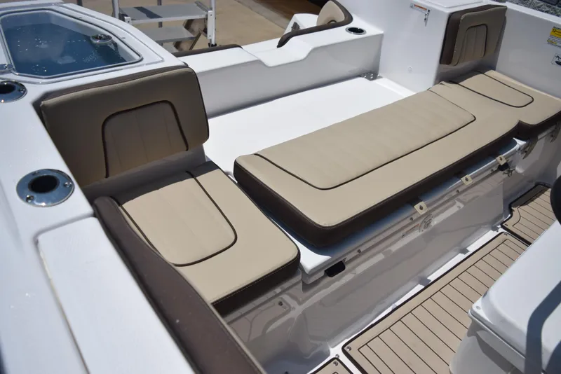 Slide: The Image of 2025 Yamaha Boats 255 FSH Sport E interior seating with beige cushions and sleek design. - 9