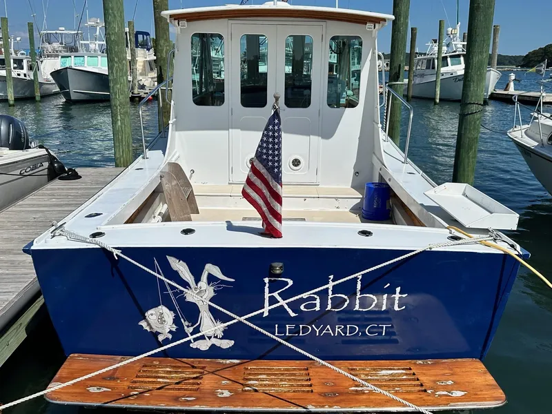 Slide: The Image of Mast & Mallet Rabbit 34 boat, 1998 model, docked with American flag, Ledyard, CT. - 1