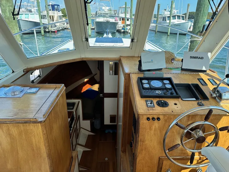 Slide: The Image of Interior of 1998 Mast & Mallet Rabbit 34 boat with navigation equipment and wooden helm. - 19