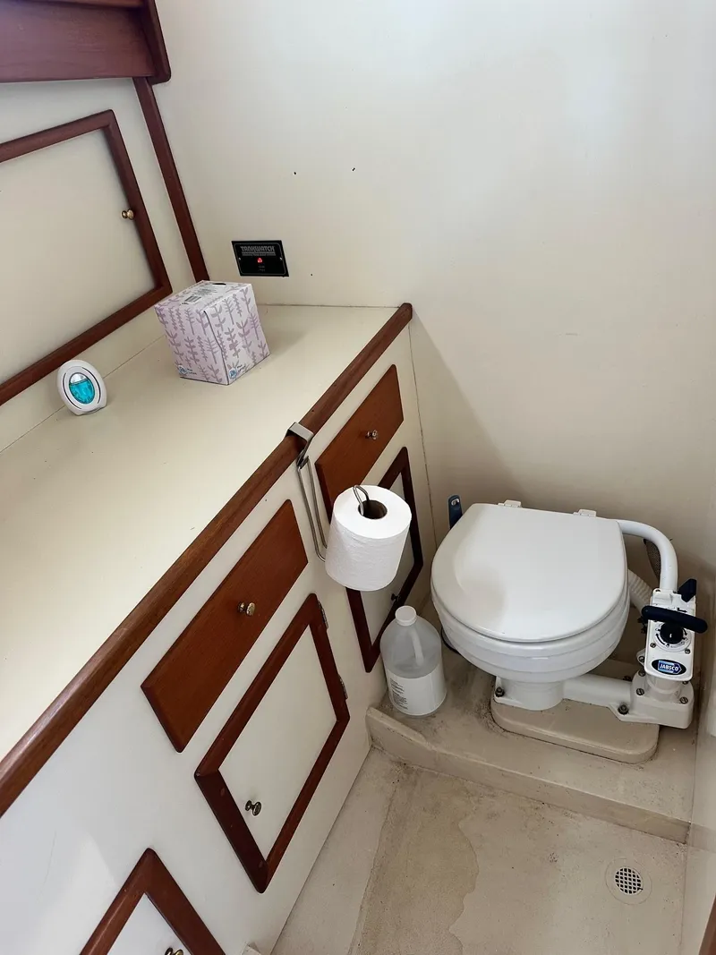 Slide: The Image of 1998 Mast & Mallet Rabbit 34 boat bathroom with toilet, cabinets, and toiletries. - 24