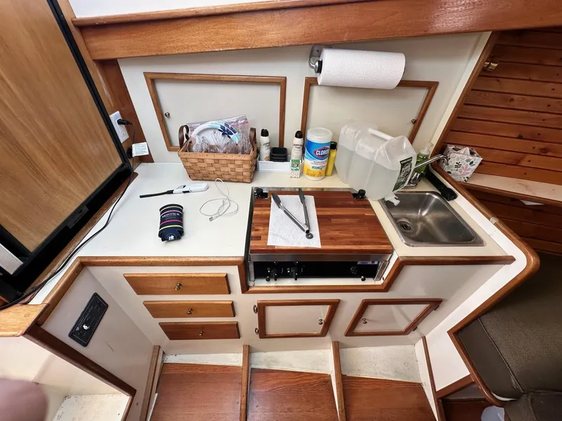 Slide: The Image of Compact kitchen area in a 1998 Mast & Mallet Rabbit 34 boat. - 25