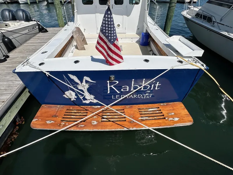 Slide: The Image of Mast & Mallet Rabbit 34 boat, 1998, docked with American flag, Ledyard, CT. - 3