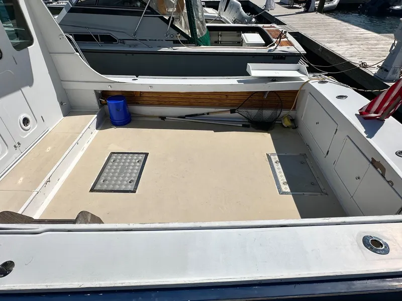 Slide: The Image of Open deck of a 1998 Mast & Mallet Rabbit 34 boat, docked at a marina. - 4