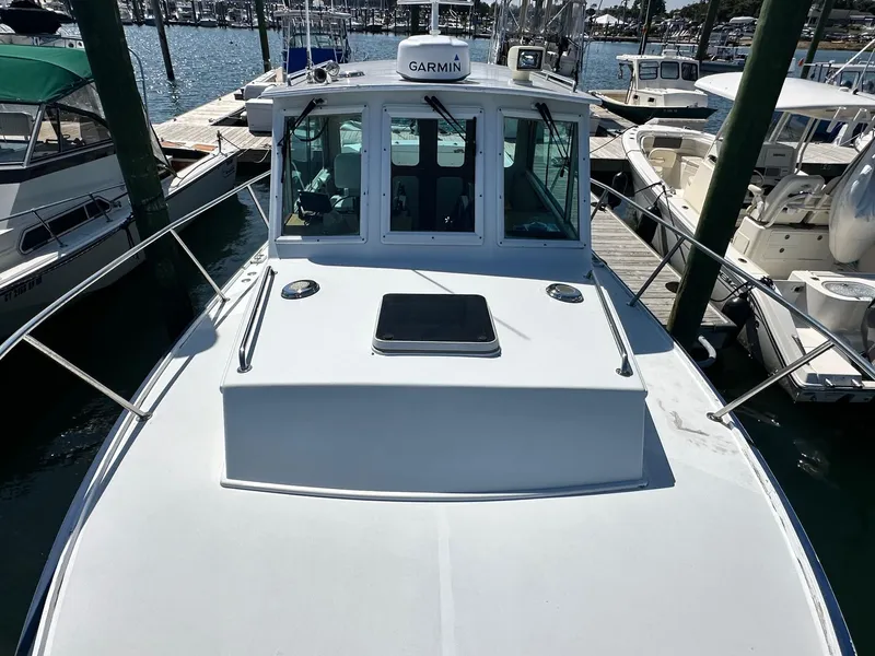 Slide: The Image of 1998 Mast & Mallet Rabbit 34 boat docked at marina, featuring Garmin equipment. - 6