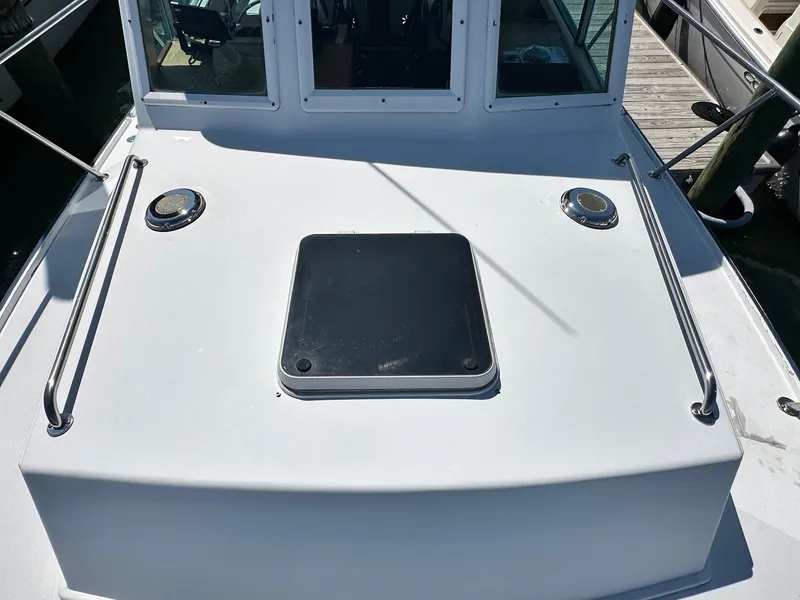 Slide: The Image of Mast & Mallet Rabbit 34 boat deck, 1998 model, featuring a hatch and railings. - 8