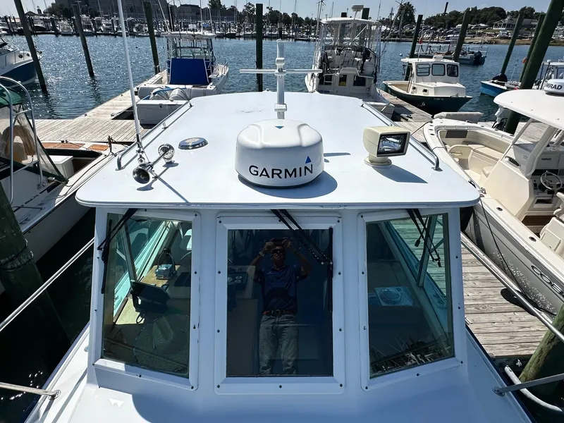 Slide: The Image of Mast & Mallet Rabbit 34 boat, 1998 model, docked with Garmin equipment visible. - 9