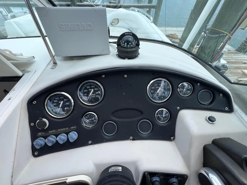 Slide: The Image of Dashboard of 2006 Hurricane SunDeck 260 OB with gauges and compass. - 13