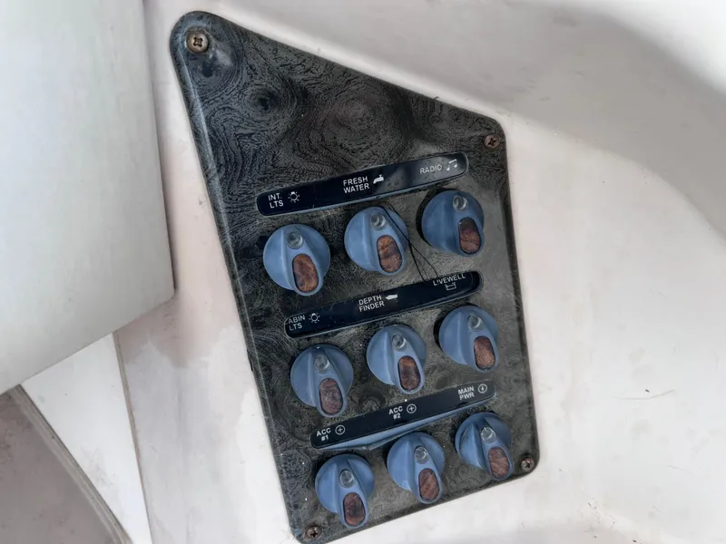 Slide: The Image of Control panel on 2006 Hurricane SunDeck 260 OB boat with switches for various functions. - 15