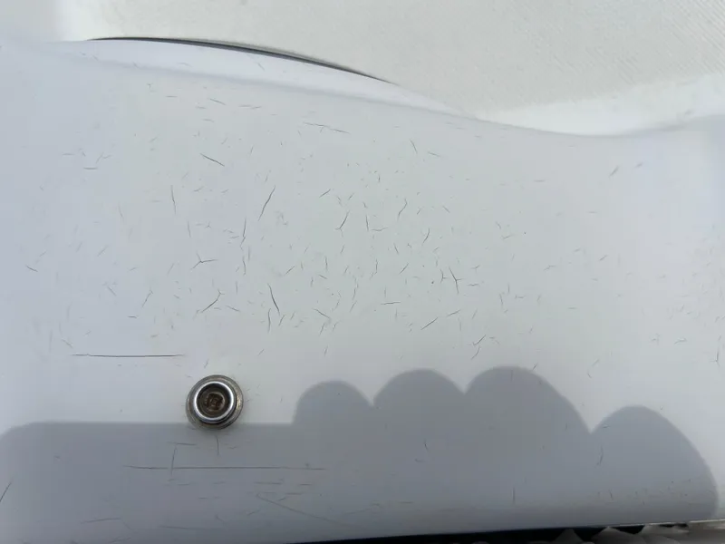 Slide: The Image of Close-up of a 2006 Hurricane SunDeck 260 OB boat surface with minor scratches. - 20