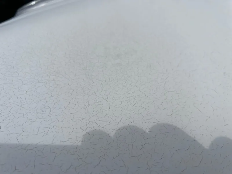 Slide: The Image of Close-up of 2006 Hurricane SunDeck 260 OB surface with visible cracks. - 21