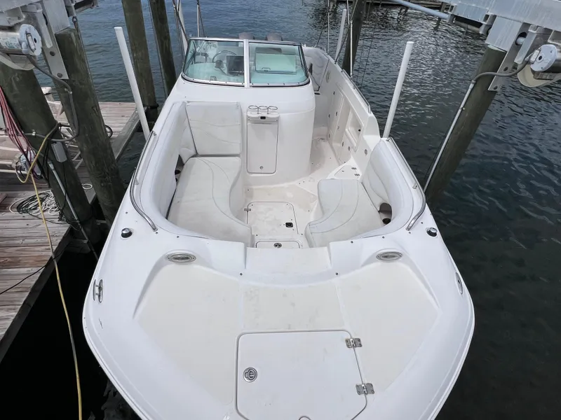 Slide: The Image of 2006 Hurricane SunDeck 260 OB boat docked, featuring spacious seating and twin Yamaha 150 engines. - 3