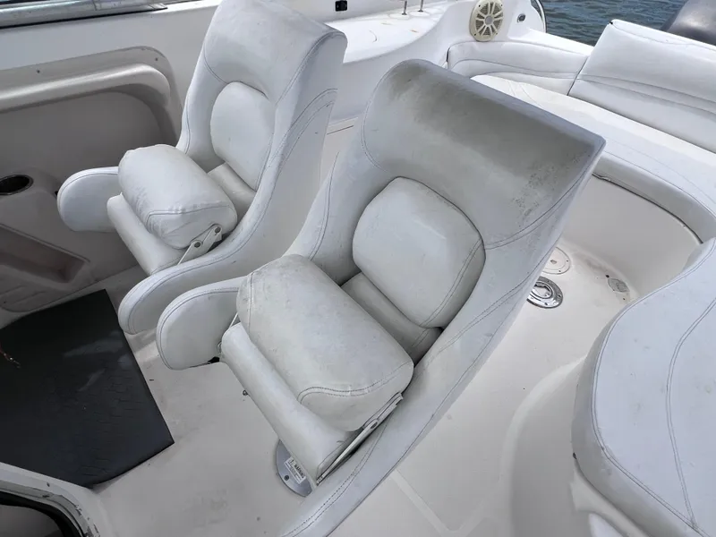 Slide: The Image of 2006 Hurricane SunDeck 260 OB boat interior with white cushioned seats. - 7