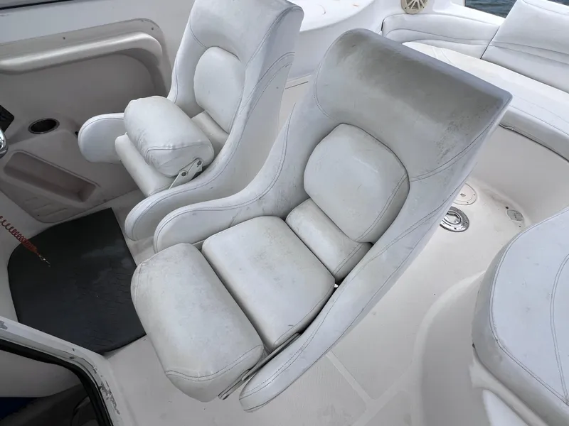 Slide: The Image of 2006 Hurricane SunDeck 260 OB boat interior with white cushioned seats. - 8