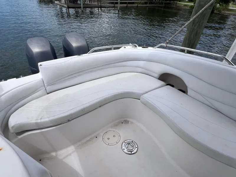 Slide: The Image of 2006 Hurricane SunDeck 260 OB boat interior with twin Yamaha 150 engines, docked by water. - 9